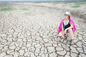 woman portrait in dryland with drought ground texture. concept climate changed.