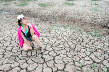woman portrait in dryland with drought ground texture. concept climate changed.