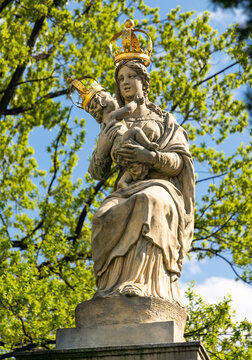 Statue of the Virgin Mary with baby Jesus in the spring garden