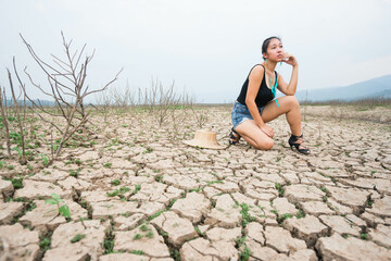 woman portrait in dryland with drought ground texture. concept climate changed.