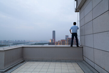 Businessman standing on the railing