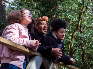 Mother with two daughters on footbridge