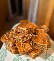 Homemade yummy, sweet baclava. Pastry with walnuts against blurry background. Baklava is the first and most authentic type of Mediterranean sweets