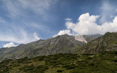 Obraz premium Rugged landscape with low formations of flora and rocky peaks of Himalayas. Kalpa, India.