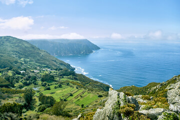 Fototapeta premium Hills, meadows and cliffs make up this colorful coastal landscape.
