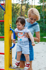 Fototapeta na wymiar beautiful girl with children on a children's playground