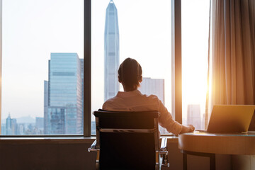 Businesswoman sitting in front of the window