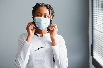 African female doctor in protective facial mask