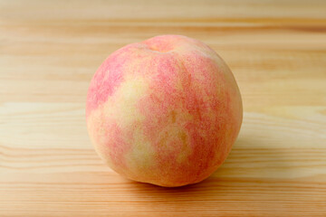 Closeup a Fresh Ripe Peach Isolated on Wooden Background