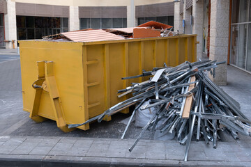 Huge heap on metal Big Overloaded dumpster waste container filled with construction waste, drywall...