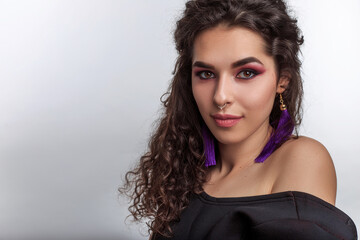 gorgeous young woman with braun glossy skin curly hair and professional make up. Indian female...