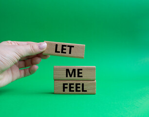 Feel symbol. Wooden blocks with words 'Let me feel'. Beautiful green background. Businessman hand. Psychology and let me feel concept. Copy space.