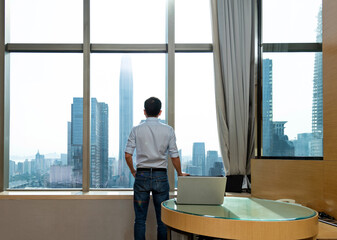 Businessman standing in front of the window