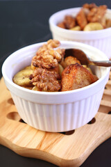 Closeup of Mouthwatering Fresh Baked Banana Walnut Bread Pudding in a White Bowl