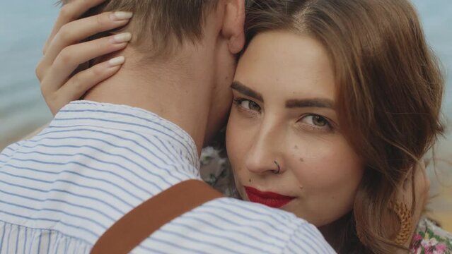 Portrait of happy loving couple, deep look of a woman at the camera, slow motion. woman with red lips.