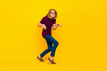 Fototapeta na wymiar Full size portrait of positive cheerful person sneaky walking toothy smile isolated on yellow color background