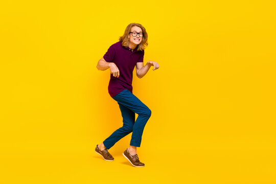 Full Size Portrait Of Positive Cheerful Person Sneaky Walking Toothy Smile Isolated On Yellow Color Background