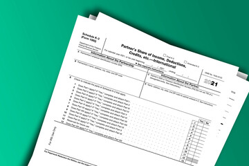 Fototapeta premium Form 1065 (Schedule K-3) documentation published IRS USA 09.13.2021. American tax document on colored