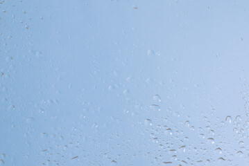 Blue backgrond with water drops. Wet glass.