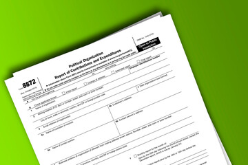 Fototapeta na wymiar Form 8872 documentation published IRS USA 41830. American tax document on colored