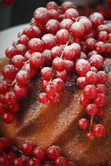 A cake with fresh red currant and tea