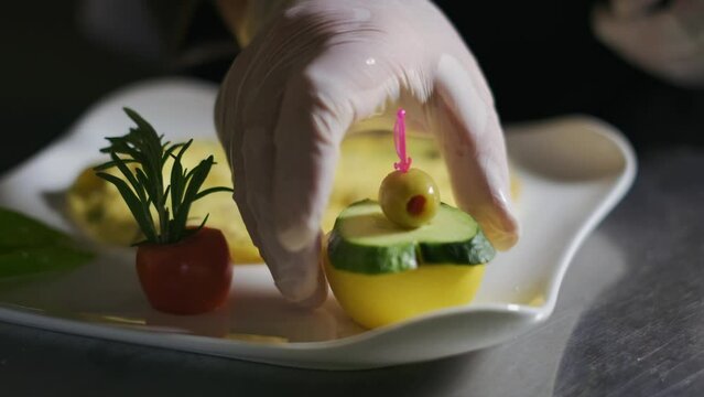The chef in the restaurant kitchen prepares omelet plate. slow motion,close up. 4K Hot Scrambled Eggs Food with Vegetable Salad on a Plate in the Kitchen