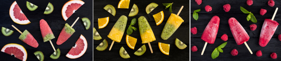 Collage of popsicle stick with kiwi, grapefruit, orange and raspberry on the black wooden  background. Top view.