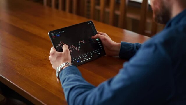 Businessman checking bitcoin price chart on digital exchange on mobile phone screen, cryptocurrency future price prediction concept