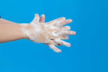 Woman rubbing fingers on blue background