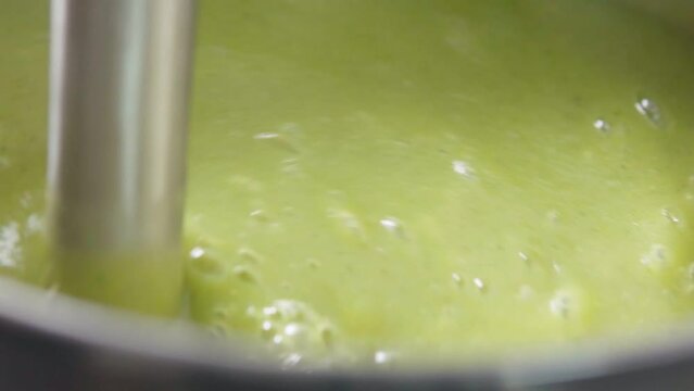 Preparation of cream soup with broccoli blender. Vegan healthy food. Close-up