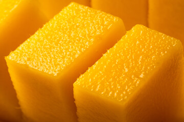 Juicy ripe yellow Thai mango on a white background. Hard light and shadow from a palm tree.