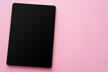 top view of digital tablet with blank screen on pink.