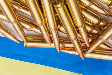 Ribbons of the Ukrainian flag and 7.62 caliber cartridges for the Kalashnikov assault rifle,...