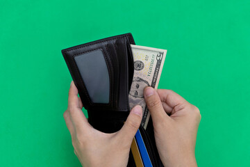Woman hand holding a leather wallet with dollar