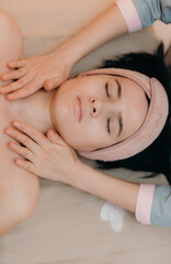 Obraz na płótnie Canvas Young beautiful woman doing face massage.