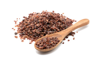 Black salt was placed in a wooden spoon and piled a lot on a completely white background.