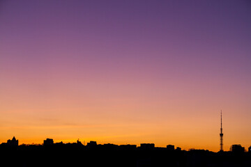 Naklejka premium Beautiful black silhouette of a city during sunset, golden hour