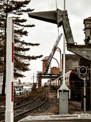 Semaphores. Railway tracks, wagons, Port cranes.
