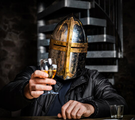 A man in a medieval iron knight's helmet.