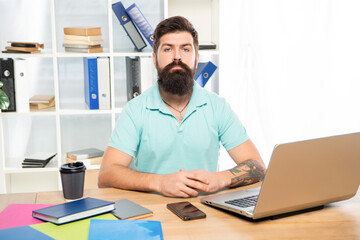 Serious professional man sitting at office desk, manager