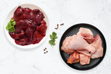 Raw Chicken meat, Chicken wings, chicken liver, and drumsticks with Indian spices. complete animal based protein source. copy space. Non vegitarian food banner. 