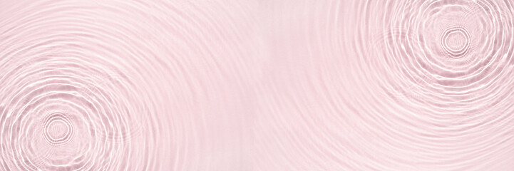 The texture of water on a pink background.
