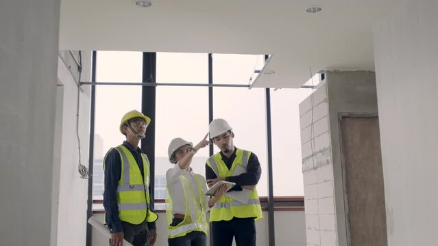 4K resolution, Asian people Engineer or Architect team inspector working inspection with technology Augmented Reality on digital tablet at construction site work.
