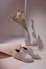 Trendy leather female sneakers. White milky color,