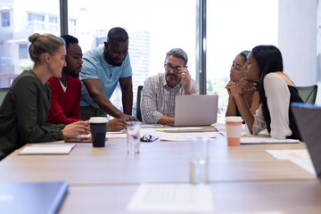 Fototapeta premium Multiracial businessmen and businesswomen discussing strategy during meeting in boardroom at office