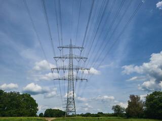Electric transmission line with high voltage pylon in Witten Germany, blue sky, contrast, no people