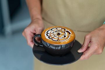 hot latte art coffee on hand table, relax time