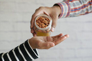 close up of almond nuts on man's hand 