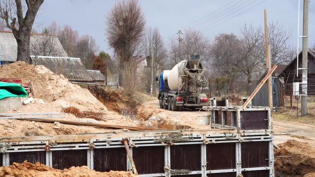Concrete casting pump. Construction machinery works on building of modern wooden house from glued beams. Ground works.. High quality 4k footage. High quality 4k footage