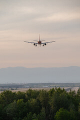 Beautiful panoramic background with flying plane in blue sky. The passenger plane with the landing gear taken off will take off in the sky. Concept of travel. Wide-angle paper or web banner 